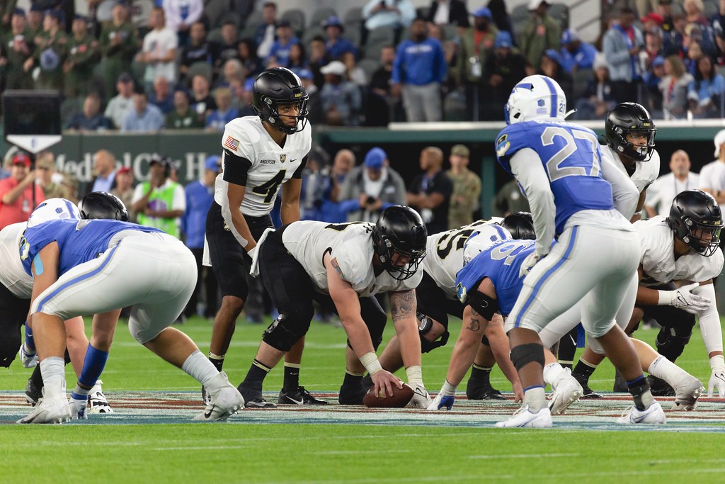Army Quarterback looks to snap the ball in front of a menacing Air Force defense